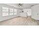 Open-concept living room with light wood flooring, neutral walls, a ceiling fan, and an eat-in kitchen at 4513 Staffordshire Ln, Charlotte, NC 28213