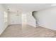 A bright living room with light wood flooring, neutral walls, a staircase and a chandelier at 4513 Staffordshire Ln, Charlotte, NC 28213