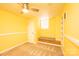 Sunny basement with beige carpet, a window with bench, and overhead ceiling fan at 4846 Midway Sand Rd, Hickory, NC 28601