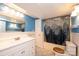 Bright bathroom featuring a mountain-themed shower curtain and white wainscoting at 4846 Midway Sand Rd, Hickory, NC 28601