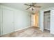 Bedroom with light green walls, closet, ceiling fan, and doorway with tile flooring at 4846 Midway Sand Rd, Hickory, NC 28601