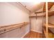 Walk-in closet with wooden shelving, rod, and hardwood floor at 4846 Midway Sand Rd, Hickory, NC 28601