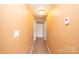 Well-lit hallway with tiled floors and neutral-colored walls, connecting different areas of the home at 4846 Midway Sand Rd, Hickory, NC 28601