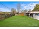 Backyard with a large lawn, utility garage, and above-ground pool at 5140 Old Monroe Rd, Indian Trail, NC 28079