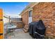 View of a patio area with a grill and hot tub outside the brick house at 5140 Old Monroe Rd, Indian Trail, NC 28079