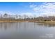 Scenic pond view with a fountain surrounded by lush trees and clear sky, offering tranquility and natural beauty at 5140 Old Monroe Rd, Indian Trail, NC 28079