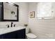 Powder room features a shiplap wall, stylish vanity, and modern black fixtures at 5217 Camilla Dr, Charlotte, NC 28226