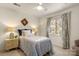 Comfortable bedroom features a ceiling fan, window, and a side table with lamps for a cozy feel at 5217 Camilla Dr, Charlotte, NC 28226