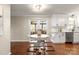 Cozy dining area featuring white cabinets, stainless steel appliances, and a view of the backyard at 5217 Camilla Dr, Charlotte, NC 28226