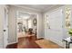 Inviting foyer with hardwood floors, a white door, and a glimpse into a cozy living space at 5217 Camilla Dr, Charlotte, NC 28226