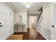 Inviting foyer with hardwood floors, white trim, stairs, and a glimpse of the living room at 5217 Camilla Dr, Charlotte, NC 28226