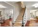 Hallway view with stairway, kitchen and office; wood floors with neutral walls at 5217 Camilla Dr, Charlotte, NC 28226