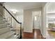 Hallway leading to carpeted staircase with wooden handrail and neutral wall colors at 5217 Camilla Dr, Charlotte, NC 28226