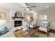 Bright living room featuring a white painted brick fireplace, a large window, and neutral decor at 5217 Camilla Dr, Charlotte, NC 28226