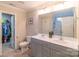 Well-lit bathroom featuring double sinks, a large mirror, and a door leading to a walk-in closet at 5413 Austin Rd # 4, Monroe, NC 28112