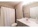 Bathroom featuring a shower with a decorative curtain, mirror, white sink and toilet at 5413 Austin Rd # 4, Monroe, NC 28112