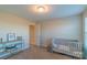 Bright bedroom with carpet, neutral walls, a white crib and shelf storage at 5413 Austin Rd # 4, Monroe, NC 28112