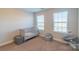 Bedroom featuring neutral colors, two large windows, and a crib at 5413 Austin Rd # 4, Monroe, NC 28112