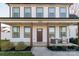 Charming front porch featuring classic columns, seating, and an inviting entryway with beautiful landscaping at 5413 Austin Rd # 4, Monroe, NC 28112