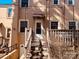 Backyard patio with string lights, an entrance awning, stairs and wood railing, and brick exterior at 565 Wakefield Dr, Charlotte, NC 28209