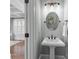 Powder room featuring pedestal sink, and detailed mirror, all complementing the home's neutral color scheme at 643 Mcalway Rd, Charlotte, NC 28211