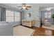 Bright Bedroom with hardwood floors, ceiling fan, leaf-themed wallpaper, and large windows at 643 Mcalway Rd, Charlotte, NC 28211