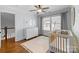 Cozy Bedroom with hardwood floors, white dresser, neutral rug, and ample natural light at 643 Mcalway Rd, Charlotte, NC 28211