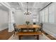 Dining area with a wooden table, unique lighting, and a convenient built-in bar space nearby at 643 Mcalway Rd, Charlotte, NC 28211