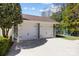 Detached two-car garage with white doors and dark hardware on concrete driveway at 643 Mcalway Rd, Charlotte, NC 28211