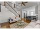 Bright living room with a staircase, an open-concept kitchen, and hardwood floors at 643 Mcalway Rd, Charlotte, NC 28211