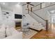 Spacious living room with a fireplace and staircase with wooden treads at 643 Mcalway Rd, Charlotte, NC 28211