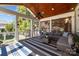 Inviting screened porch featuring wood ceiling, comfortable seating, and a blue striped rug at 643 Mcalway Rd, Charlotte, NC 28211