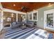 Relaxing screened porch with cozy seating, blue striped rug, and serene backyard views at 643 Mcalway Rd, Charlotte, NC 28211