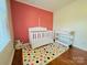 Bright Bedroom featuring a colorful polka dot rug, crib, and changing table at 7025 Spring Morning Ln, Charlotte, NC 28227