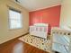 Bedroom featuring a colorful polka dot rug, a crib, and a changing table at 7025 Spring Morning Ln, Charlotte, NC 28227