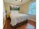 Cozy bedroom featuring mountain art above the bed and wood-look floors at 7025 Spring Morning Ln, Charlotte, NC 28227