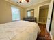 Cozy bedroom featuring a large window, neutral color palette and well-maintained hardwood floors at 7025 Spring Morning Ln, Charlotte, NC 28227