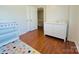 Bedroom featuring a changing table and a white dresser at 7025 Spring Morning Ln, Charlotte, NC 28227