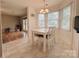 Bright breakfast nook featuring lots of natural light and a modern chandelier at 7025 Spring Morning Ln, Charlotte, NC 28227