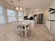 Bright breakfast nook featuring lots of natural light, view of the kitchen, and a modern chandelier at 7025 Spring Morning Ln, Charlotte, NC 28227