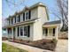 Charming two-story home featuring a welcoming side porch with landscaped garden at 7025 Spring Morning Ln, Charlotte, NC 28227