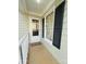 Cozy front porch featuring a 'Welcome' mat, storm door and a window with dark shutters at 7025 Spring Morning Ln, Charlotte, NC 28227