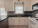 Well-lit kitchen with stainless steel appliances, granite countertops, and decorative backsplash at 7025 Spring Morning Ln, Charlotte, NC 28227