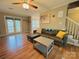 Bright living room featuring hardwood floors, a brick fireplace, and access to the backyard at 7025 Spring Morning Ln, Charlotte, NC 28227