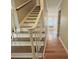 Staircase with hardwood stairs and white railing at 7025 Spring Morning Ln, Charlotte, NC 28227