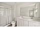 Bathroom with double sink vanity, large mirror, and tiled shower at 8010 Bruce St, Charlotte, NC 28215