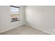 Empty bedroom features a window, neutral carpet and light-colored walls at 8010 Bruce St, Charlotte, NC 28215