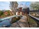 Backyard view with an in-ground swimming pool needing repair adjacent to the home at 82 Paddington Sw Dr, Concord, NC 28025