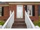 Brick home entrance with steps and white railings at 82 Paddington Sw Dr, Concord, NC 28025