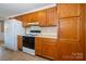 Kitchen featuring wooden cabinets, laminate countertops and a range at 82 Paddington Sw Dr, Concord, NC 28025